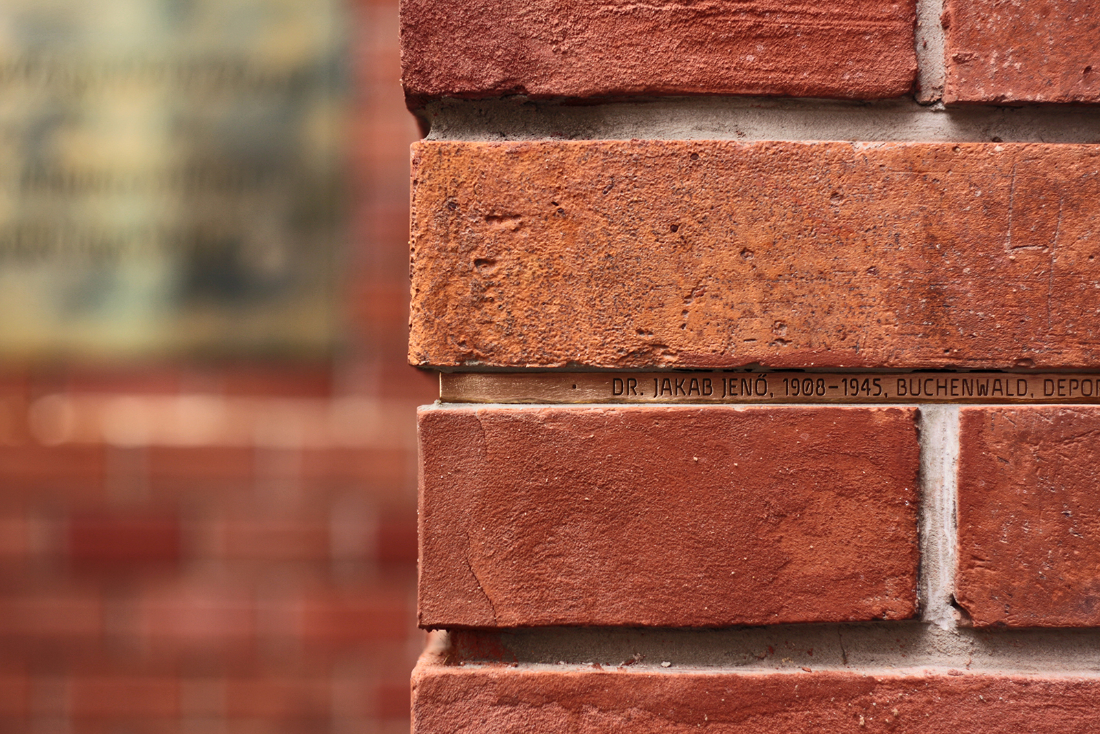 Trefort Monument — bronze name plate set between bricks